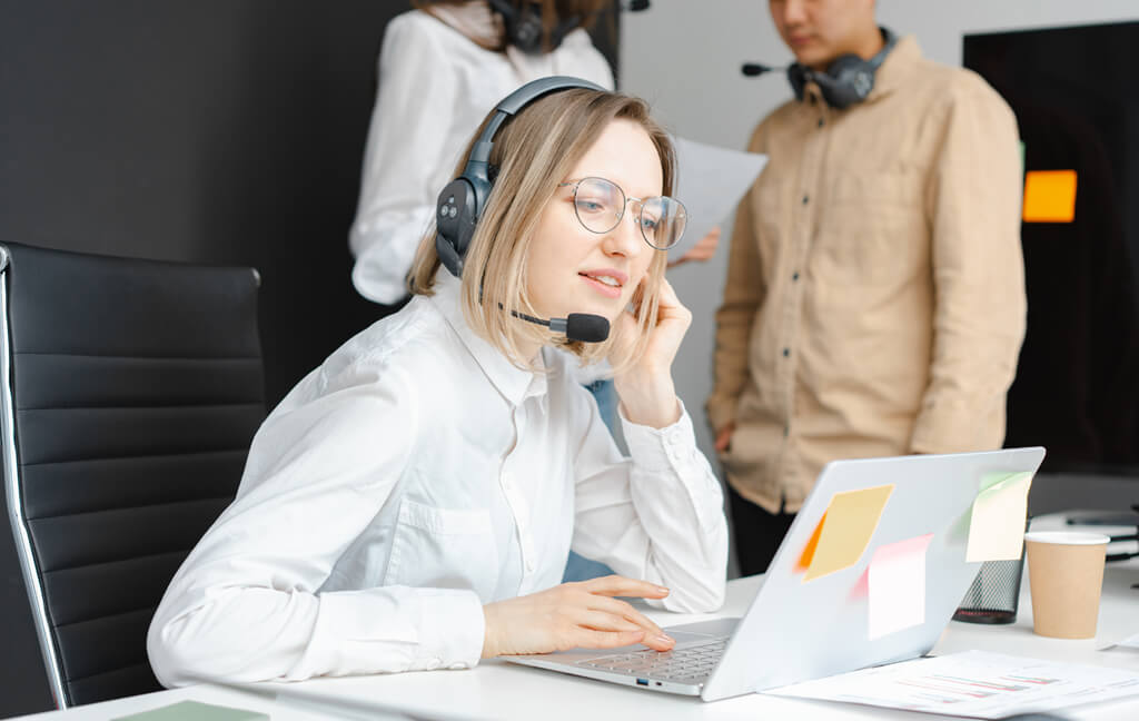A team discussing a software issue at a workstation
